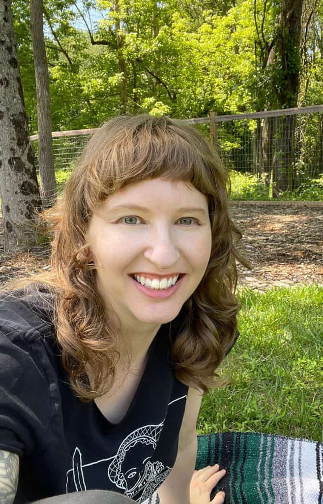 A picture of Rebecca in a forest setting