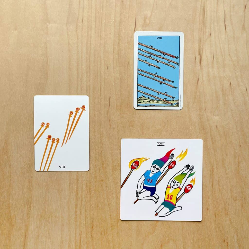 A picture of tarot cards from the Laughing Eye Weeping Eye tarot, the Rider Waite Smith Tarot, and the Colorful Tears Tarot