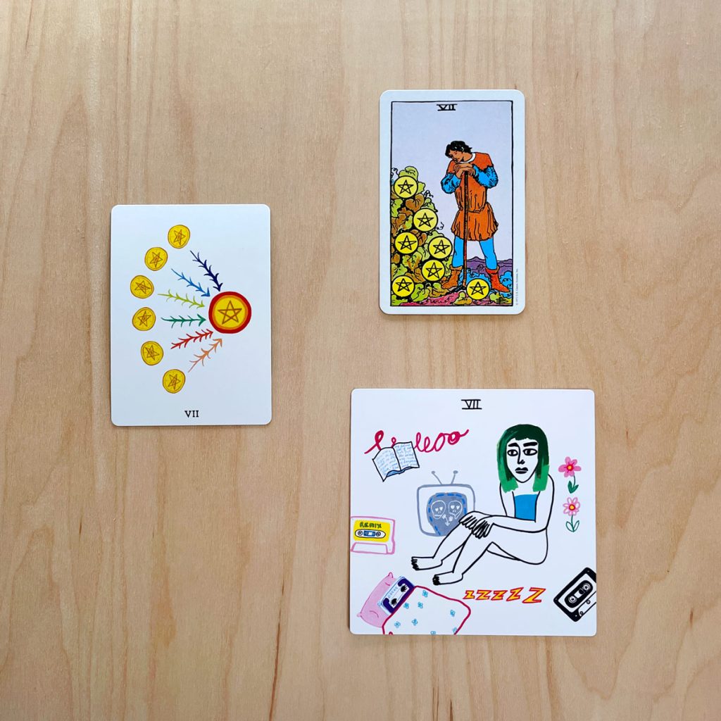 This is an image of the Seven of Pentacles from the Laughing Eye Weeping Eye tarot, the Rider Waite tarot, and the Colorful Tears Tarot